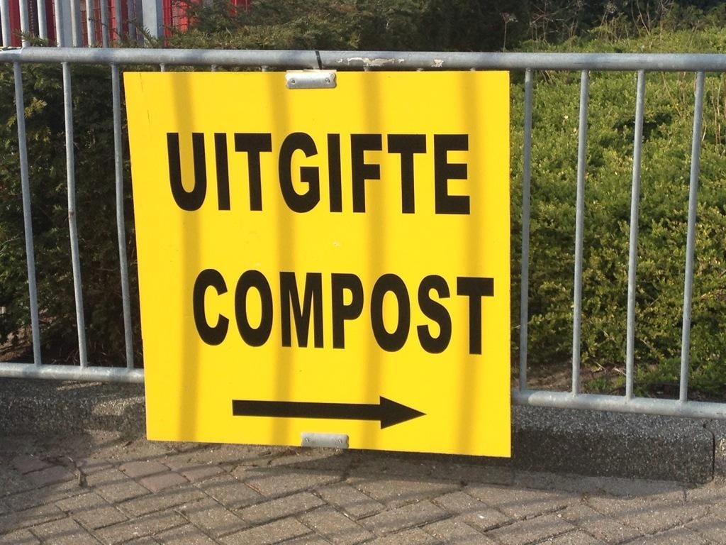 Bord op hek met daarop: Uitgifte Compost